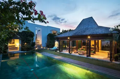a villa with a swimming pool at night at Elegant Villa Casabianca - Tropical Pool & Garden, Near Potato Head Beach Club! in Seminyak