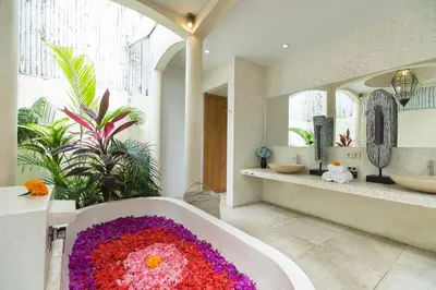 a bathroom with a tub covered in flowers at Elegant Villa Casabianca - Tropical Pool & Garden, Near Potato Head Beach Club! in Seminyak