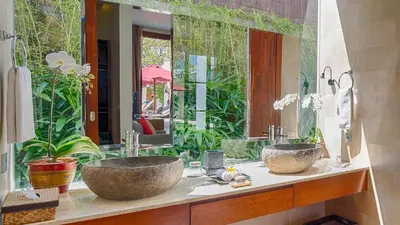 a bathroom with two sinks and a large mirror at Casa Brio in Seminyak