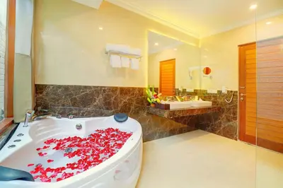 a bathroom with a tub filled with red roses at Villa Alessandra Seminyak By Bali Asia Villa in Seminyak