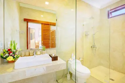 a bathroom with a toilet and a sink and a shower at Villa Alessandra Seminyak By Bali Asia Villa in Seminyak