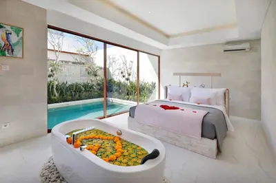a bedroom with a bed and a tub filled with food at La Vie Villa Seminyak by Ini Vie Hospitality in Seminyak