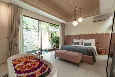a bedroom with a bed and a large window at La Vie Villa Seminyak by Ini Vie Hospitality in Seminyak