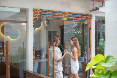 a man and woman standing outside of a glass door at La Vie Villa Seminyak by Ini Vie Hospitality in Seminyak
