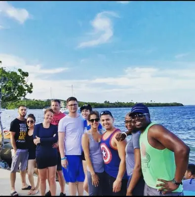 a group of people standing next to a body of water at Tanjung Sari Inn in Nusa Dua