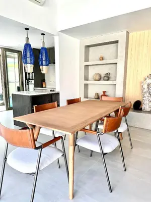a dining room with a wooden table and chairs at Villa Ria Bali in Seminyak