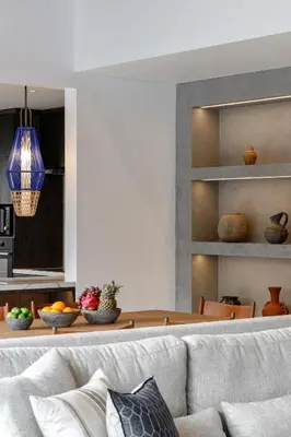 a living room with a couch and a kitchen at Villa Ria Bali in Seminyak
