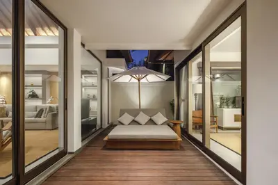 a bedroom with a bed and a living room at Villa Ria Bali in Seminyak