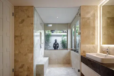a bathroom with a sink and a tub at Villa Ria Bali in Seminyak