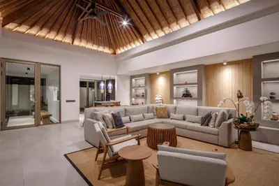 a living room with a couch and a table at Villa Ria Bali in Seminyak