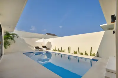 a swimming pool in the middle of a house at The Grand Daha Luxury Villas in Seminyak