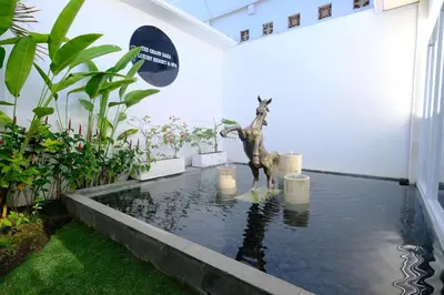 a statue of a dog standing in a pool of water at The Grand Daha Luxury Villas in Seminyak