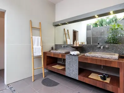 a bathroom with two sinks and a large mirror at Villa Arte by Villa Finder in Seminyak