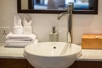 a bathroom with a white sink and a mirror at Villa CJ Seminyak in Seminyak