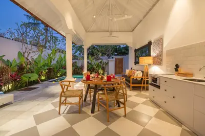 a kitchen and dining room with a table and chairs at Villa CJ Seminyak in Seminyak