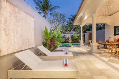 a villa with a swimming pool and a patio at Villa CJ Seminyak in Seminyak