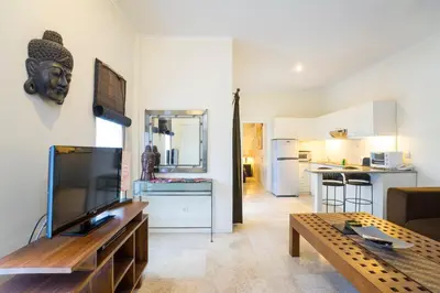 a living room with a couch and a table at Beach Melati Apartments in Legian