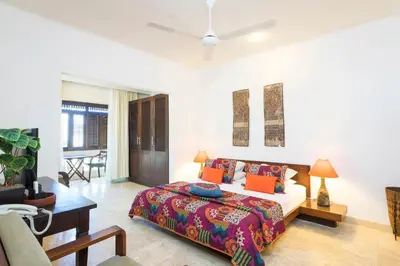 a bedroom with a bed and a living room at Beach Melati Apartments in Legian