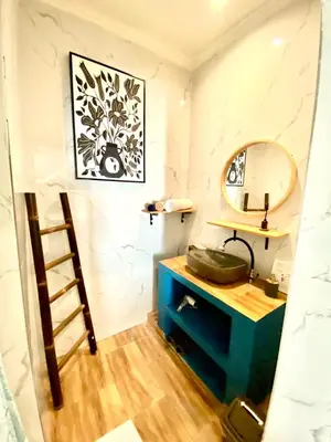 a bathroom with a sink and a mirror at Kubu Guest House in Seminyak