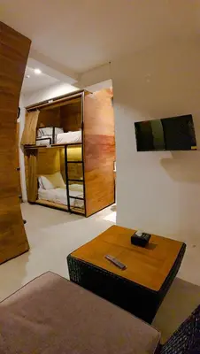 a living room with a table and bunk beds at DBeds Kuta Beach in Kuta