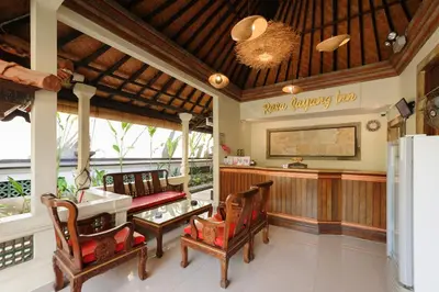 a living room with a couch and a table at Urbanview Hotel Rasa Sayang Inn Tanjung Benoa Bali in Nusa Dua