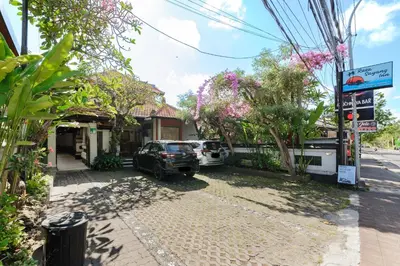 a house with a car parked in the driveway at Urbanview Hotel Rasa Sayang Inn Tanjung Benoa Bali in Nusa Dua