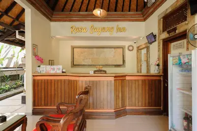 a bar in a restaurant with a sign on the wall at Urbanview Hotel Rasa Sayang Inn Tanjung Benoa Bali in Nusa Dua