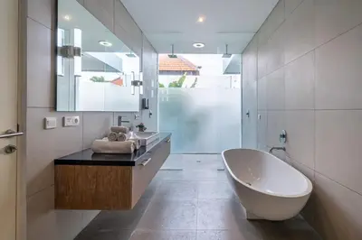 a bathroom with a white tub and a sink at Villa Jekumah 3 in Seminyak