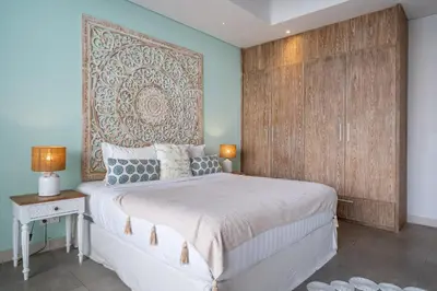 a bedroom with a large bed and a large wall at Villa Jekumah 3 in Seminyak