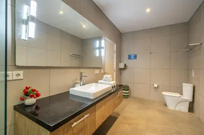 a bathroom with a sink and a toilet at Villa Jekumah 3 in Seminyak