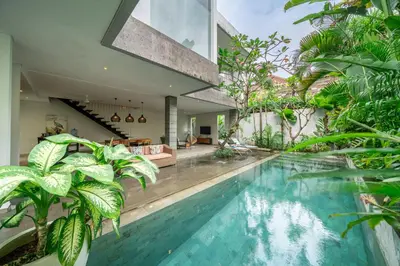 an indoor pool in a house with plants at Villa Jekumah 3 in Seminyak