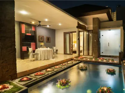 a pool in the middle of a room with a table at Samaja Beachside Villas in Seminyak