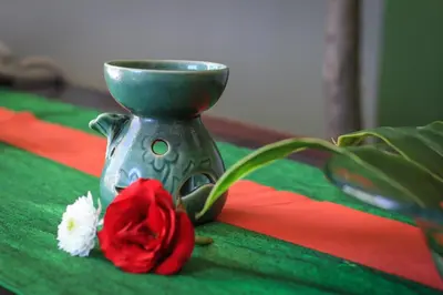 a silver vase with a red rose on a table at Samaja Beachside Villas in Seminyak