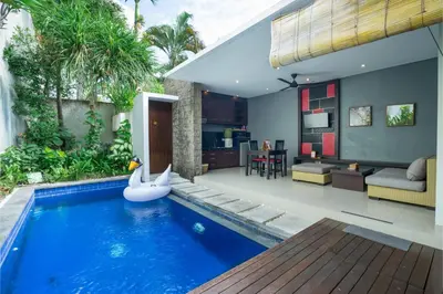 a swimming pool with a inflatable swan in a house at Samaja Beachside Villas in Seminyak