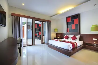 a bedroom with a large bed and a dining room at Samaja Beachside Villas in Seminyak