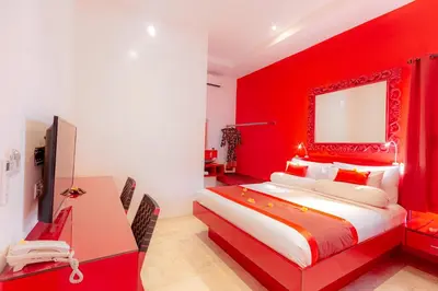 a red bedroom with a bed and a desk at Bali Ginger Suites & Villa in Seminyak