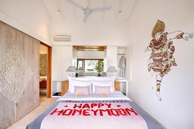 a bedroom with a happy birthday cake on a bed at The Jimbaran Villa by Ini Vie Hospitality in Jimbaran