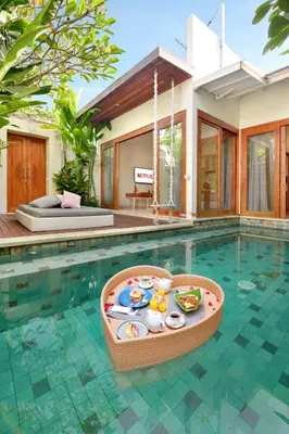 a swimming pool with a toy in the middle of a house at The Jimbaran Villa by Ini Vie Hospitality in Jimbaran