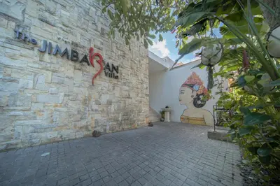 a brick wall with graffiti on the side of a building at The Jimbaran Villa by Ini Vie Hospitality in Jimbaran