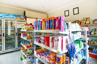 a store filled with lots of books on shelves at Lembayung Sari Homestay in Denpasar