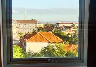a view of a city from a window at Ibis Bali Kuta in Kuta