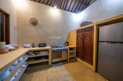 a kitchen with a stove and a counter top at Rumi Villas in Seminyak