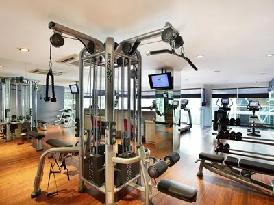 a gym with several treadmills and machines at Grand Mega Resort & Spa Bali in Kuta