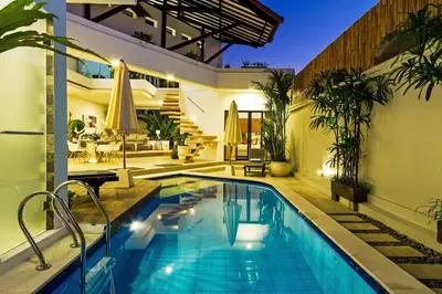 an outdoor swimming pool in a house with a house at Villa Serasi in Canggu
