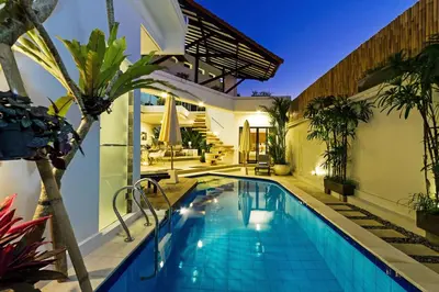 a swimming pool in the backyard of a house at Villa Serasi in Canggu