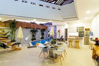 a kitchen and living room with a swimming pool at Villa Serasi in Canggu