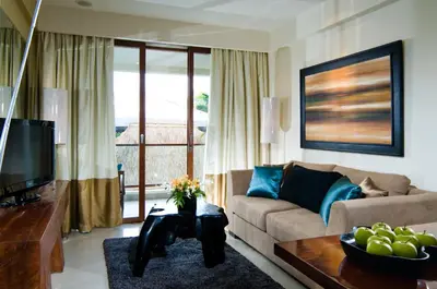 a living room with a couch and a table at Kuta Luxury Residence in Kuta