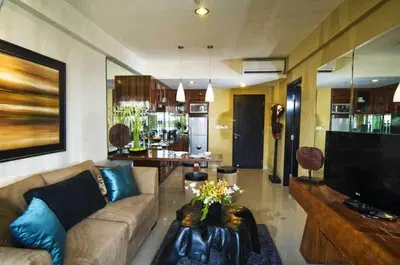 a living room with a couch and a tv at Kuta Luxury Residence in Kuta
