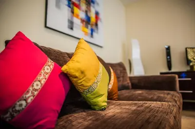 a couch with two colorful pillows on it at O Villas Seminyak in Seminyak