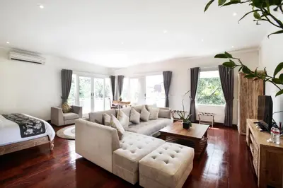 a living room with a couch and a table at Villa Marronniers in Seminyak